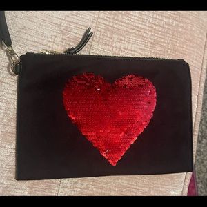 Brand new large black wristlet with sequin heart purchased from Macys